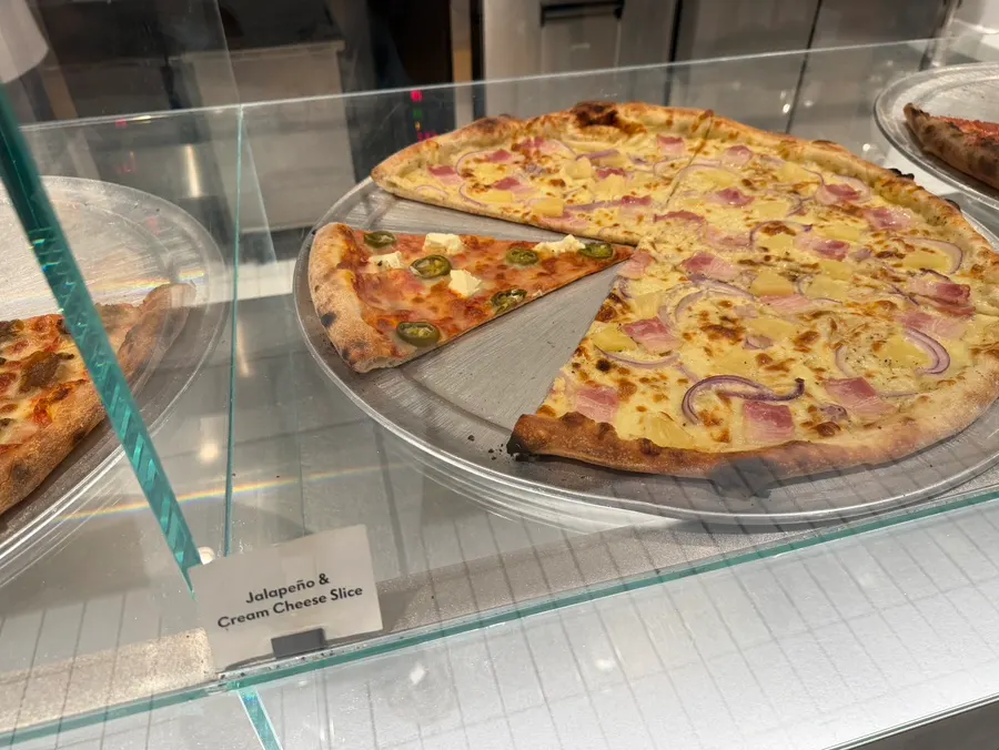 Various pizza slices inside the showcase