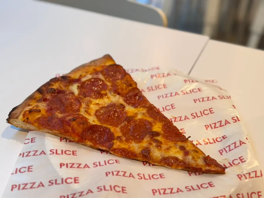 Pepperoni slice piled high with toppings
