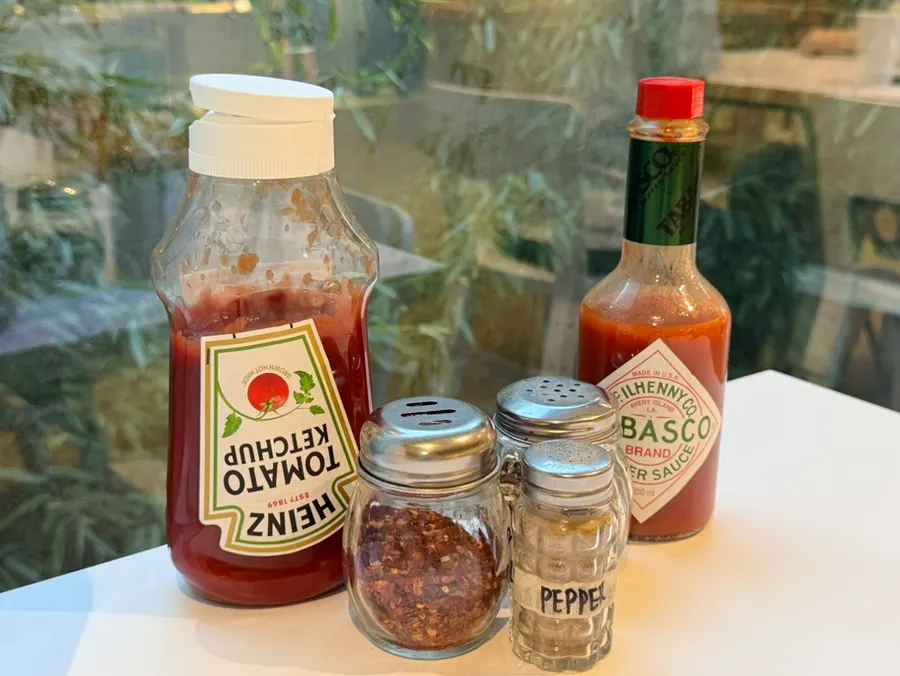 Ketchup, hot sauce, and seasonings on the table