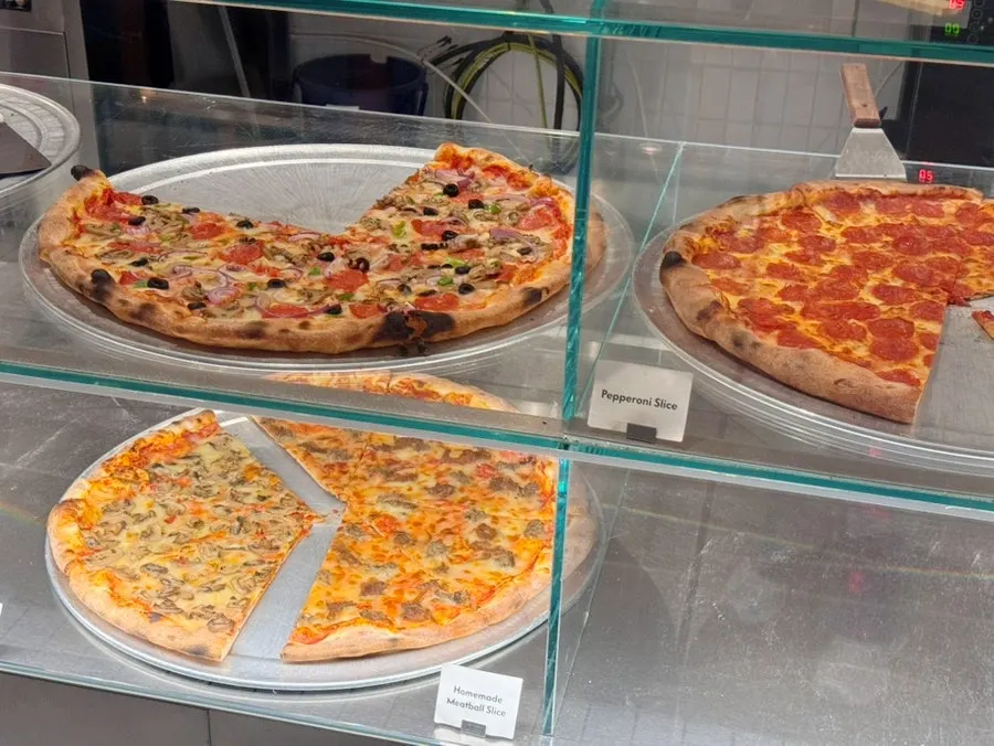 A spread of pizza, fries, and coke together
