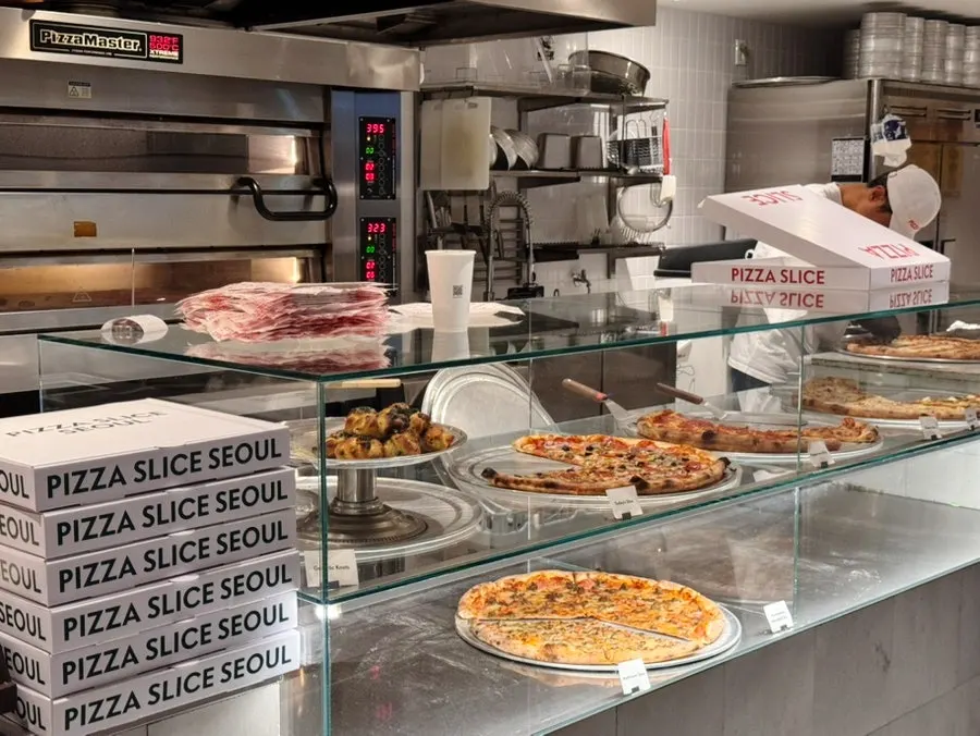 Enjoying solo slices at the bar table