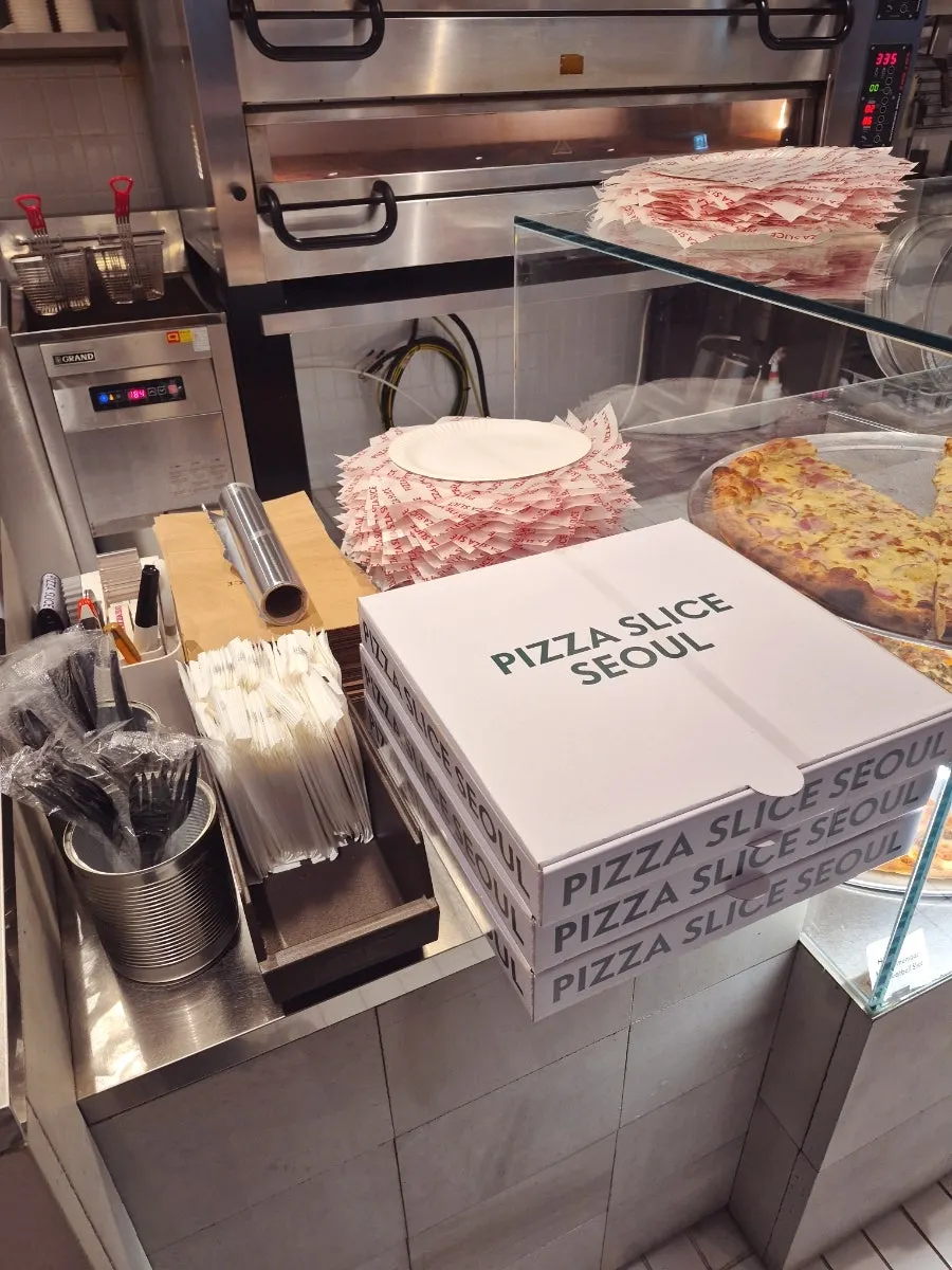 Business cards and self-serve fork and wet wipe corner at the counter