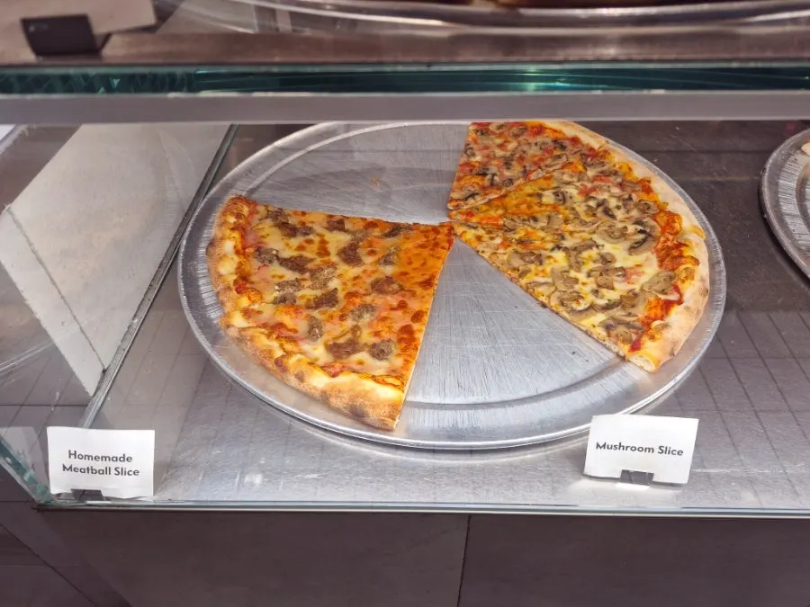 Various slice pizzas in the showcase