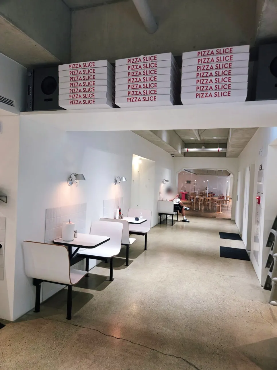 Open interior connected to the café through floor-to-ceiling glass