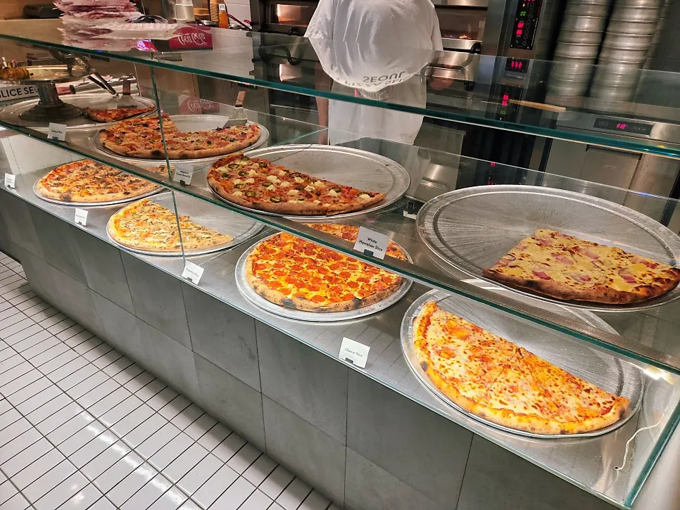 Pizza display case with sliced pizzas