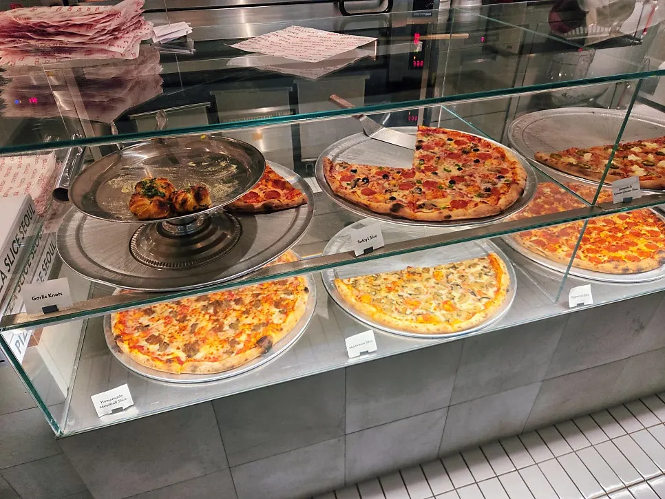 American-style pizza slices lined up in the display case
