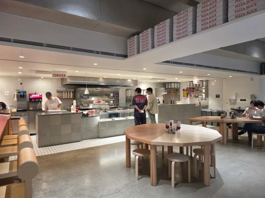 Bright white, spacious interior of Pizza Slice Seoul