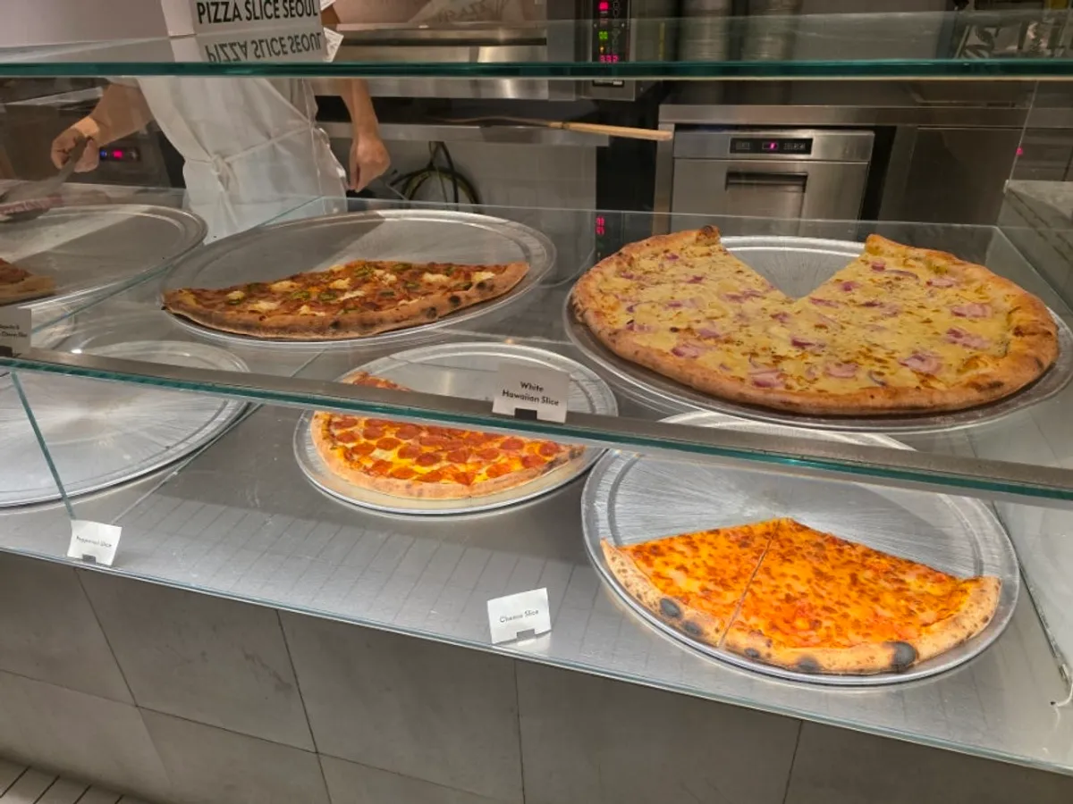 Hall seating with generous table spacing at Pizza Slice Seoul