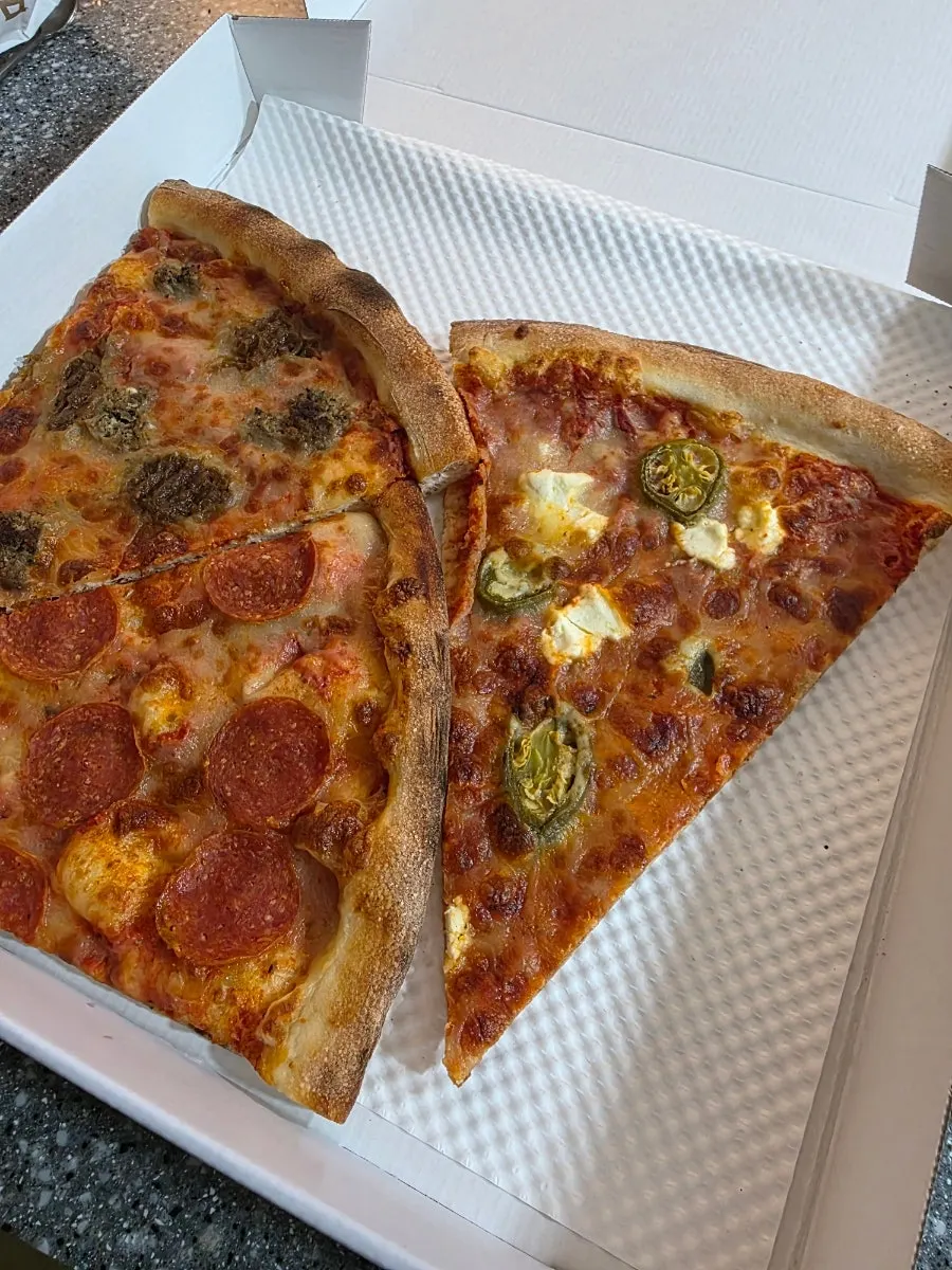 Close-up of jalapeño cream cheese pizza slice