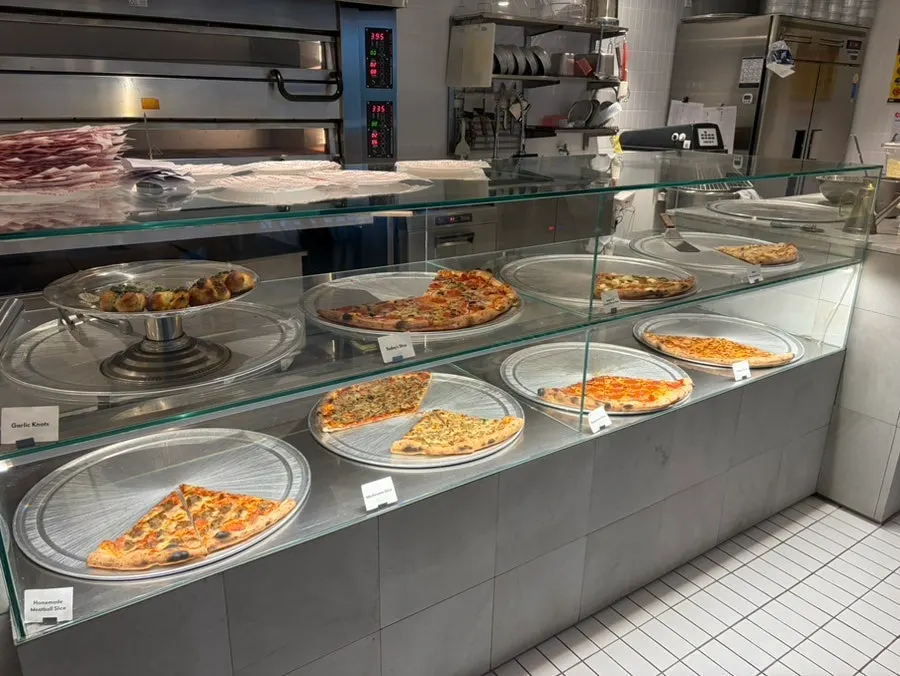 Pizza display case with slice pizzas on show