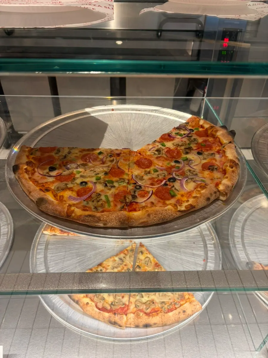 Pizza boxes stacked high near the order counter