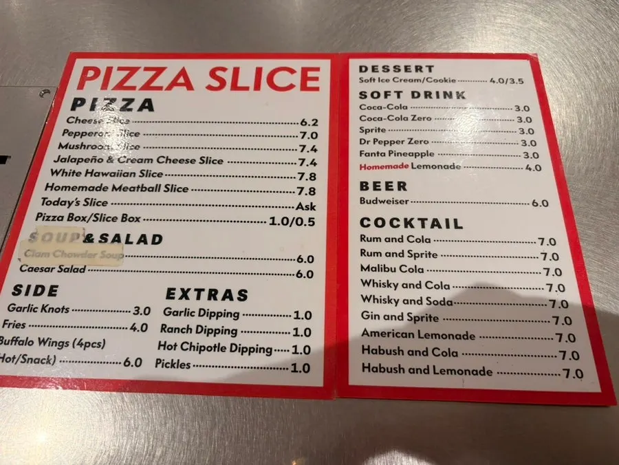 Menu board listing pizzas and drinks