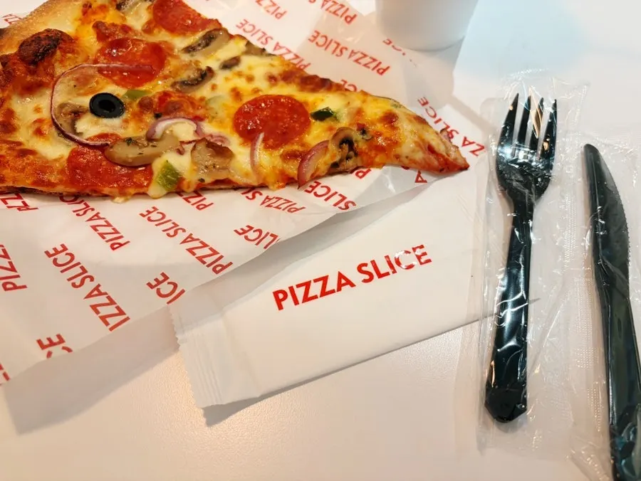 Slice of pizza placed on parchment paper