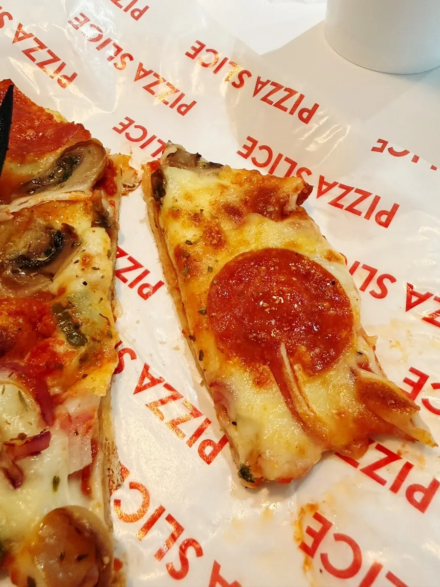 Close-up of a pepperoni-topped pizza slice