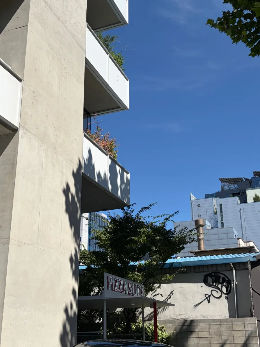 Clean white building exterior with plants