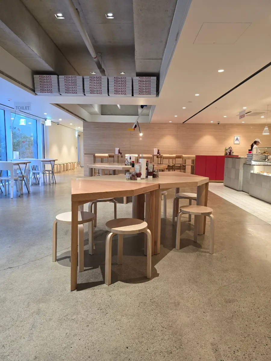 Basement dining hall with wide table spacing