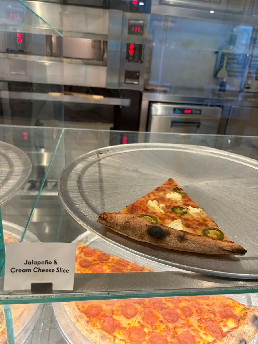 Large pizza slices displayed in the showcase