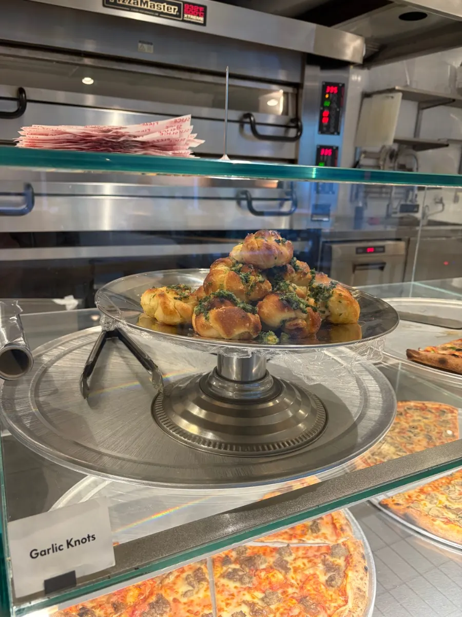 Jalapeño cream cheese pizza slice on display