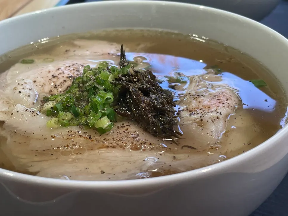 Lifting meat out of the clear gomtang broth