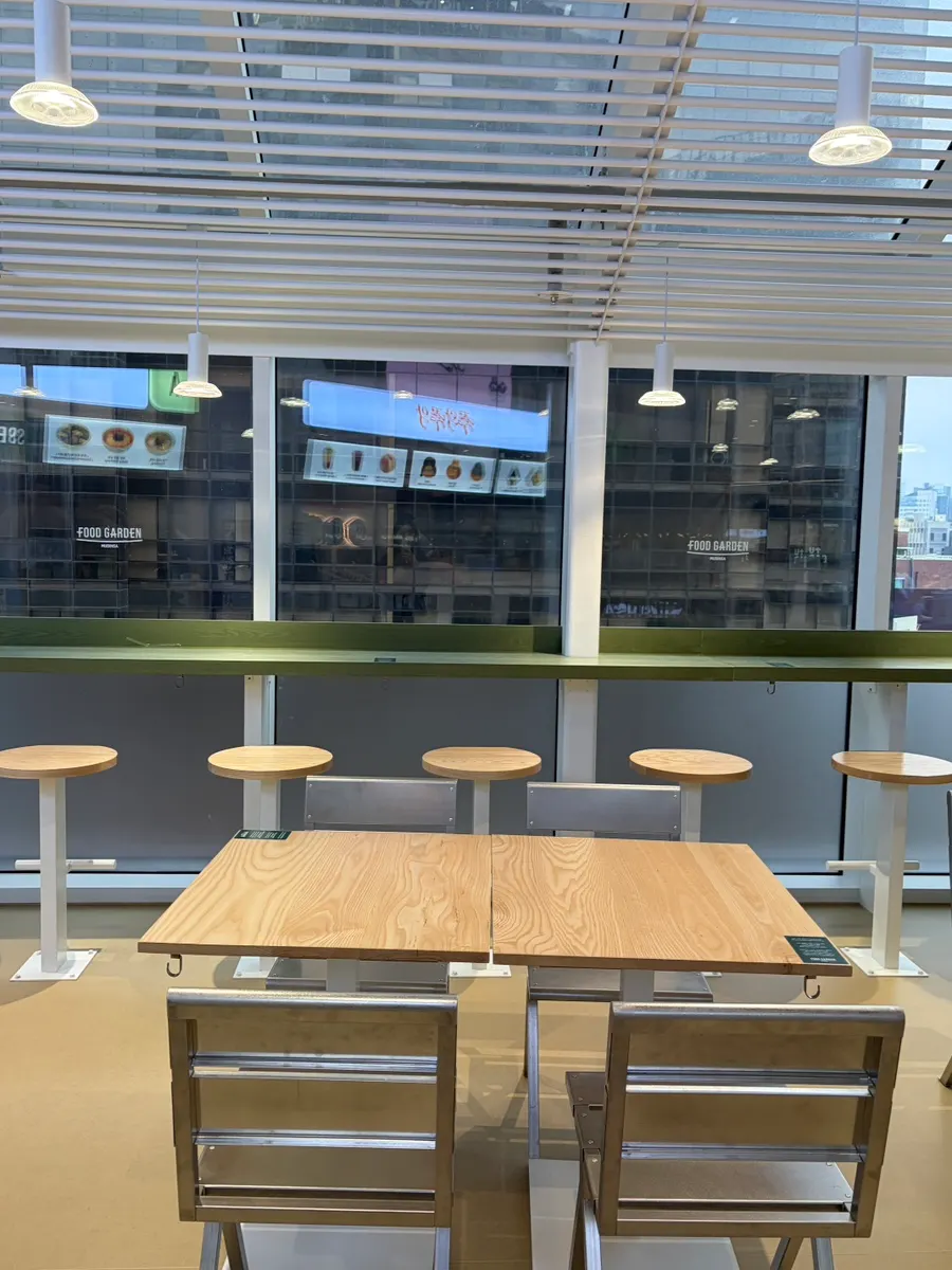 Window-side table seating at the Food Garden