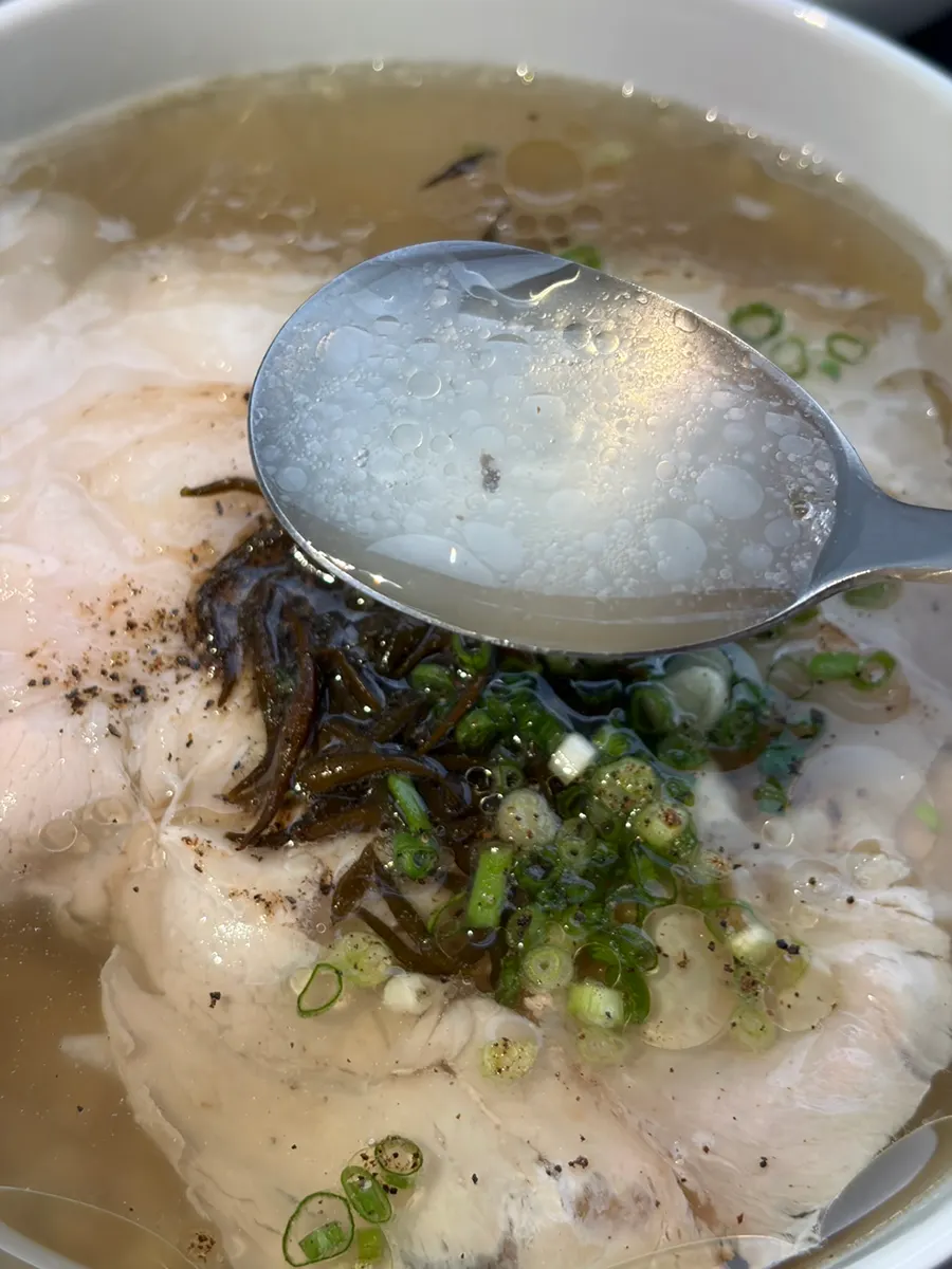 Clear pork gomtang broth topped with tot