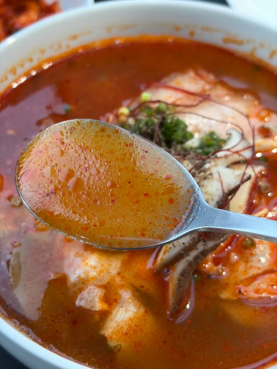 Spicy gomtang broth topped with shiitake mushroom