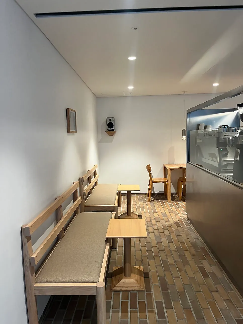 Bench seat corner with framed art and speaker props