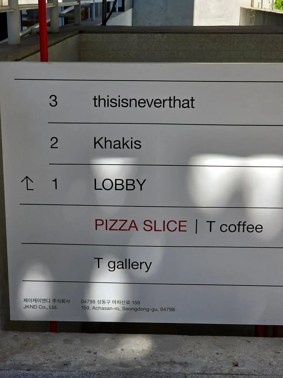 Entrance with T Coffee's business hours posted