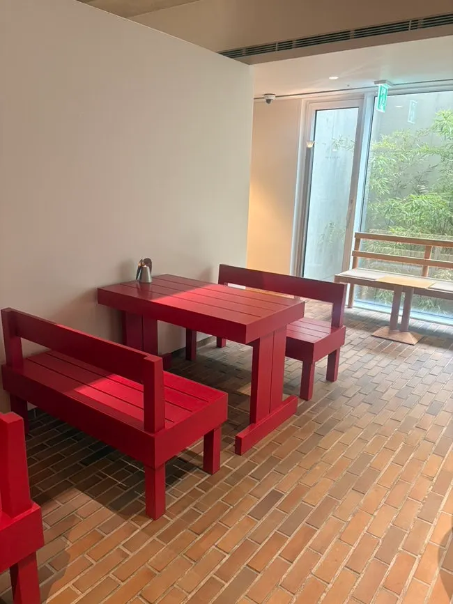 Interior of T Coffee with wood furniture and spaced-out seating