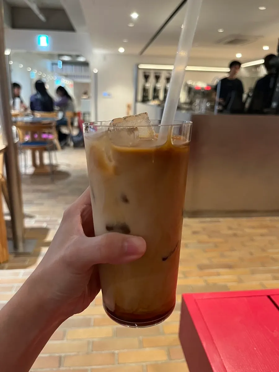 Almond latte served with a tea coaster