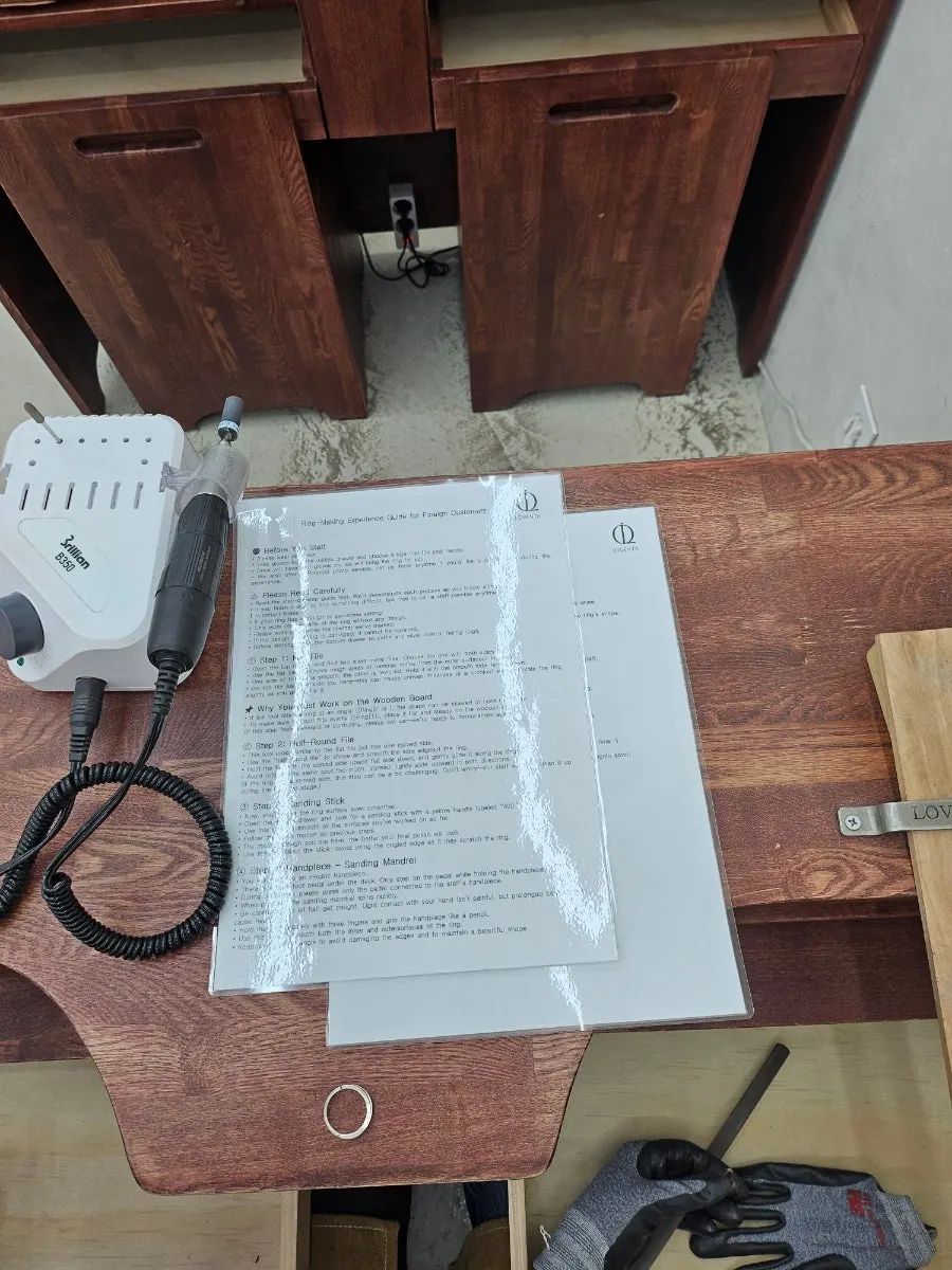 Filing a ring while wearing an apron and gloves