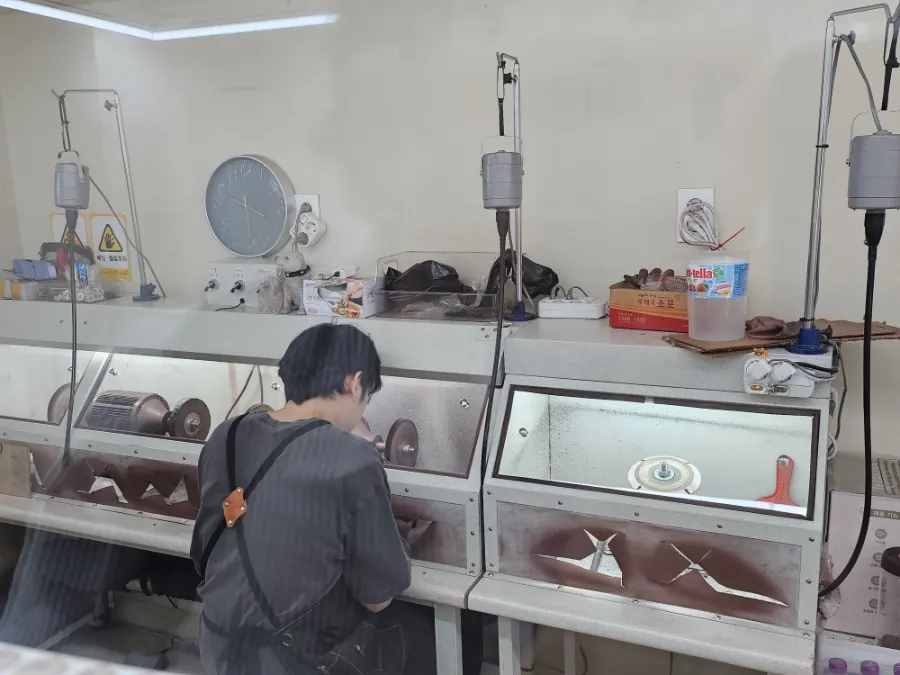Staff performing the final finishing work in the workshop