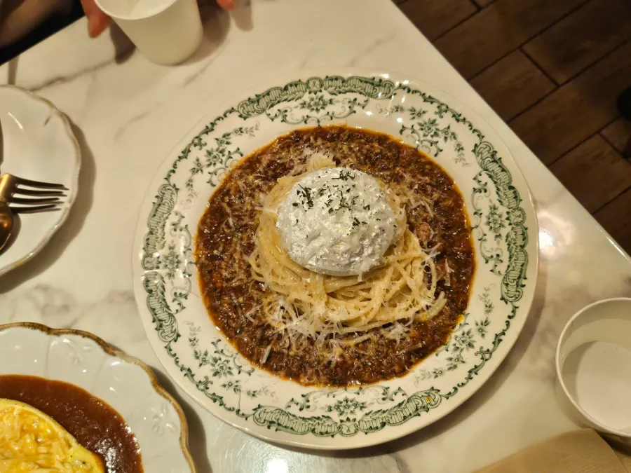 Pasta topped with a fresh-cream burrata-cheese garnish