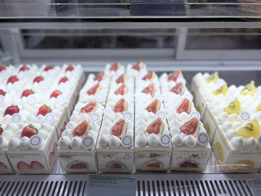 Dessert display with fruit-shaped cakes and more