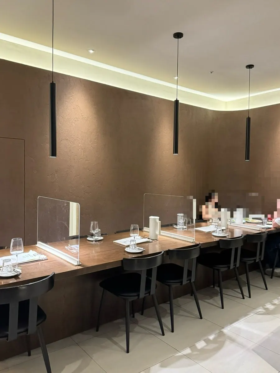Interior of Sedici with sunlight streaming through the floor-to-ceiling windows