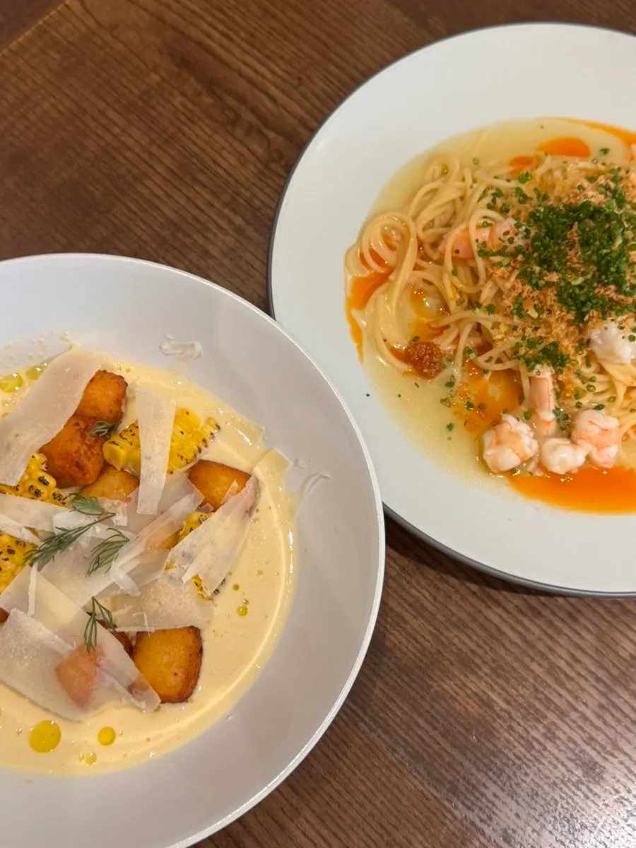 Fried potato gnocchi scooped up with corn sauce