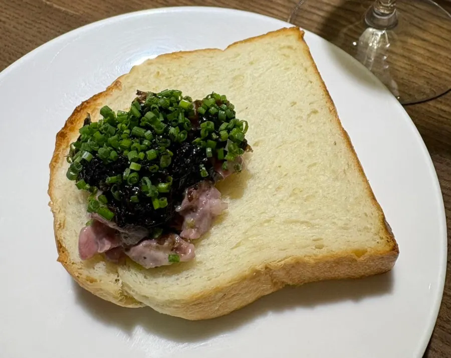 Close-up of beef tartare garnished with a yellow flower