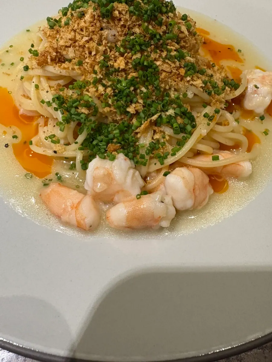 Shrimp crumble pasta with plump shrimp on top