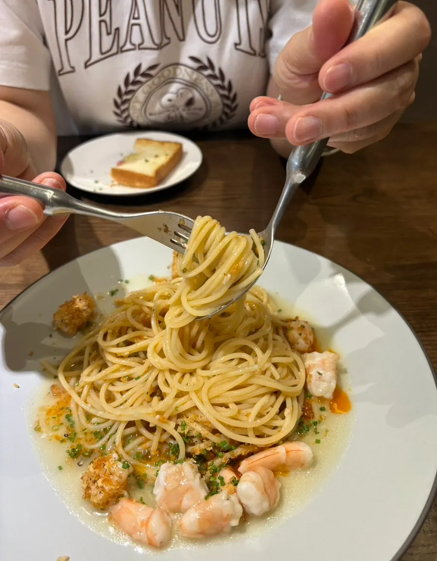 A forkful of noodles lifted from the shrimp crumble pasta