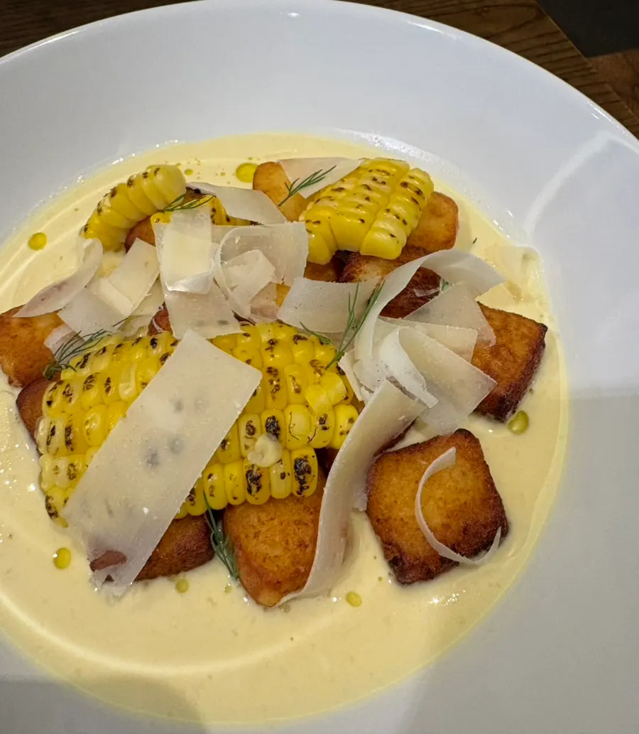 Gnocchi plated with grilled sweet corn and herbs
