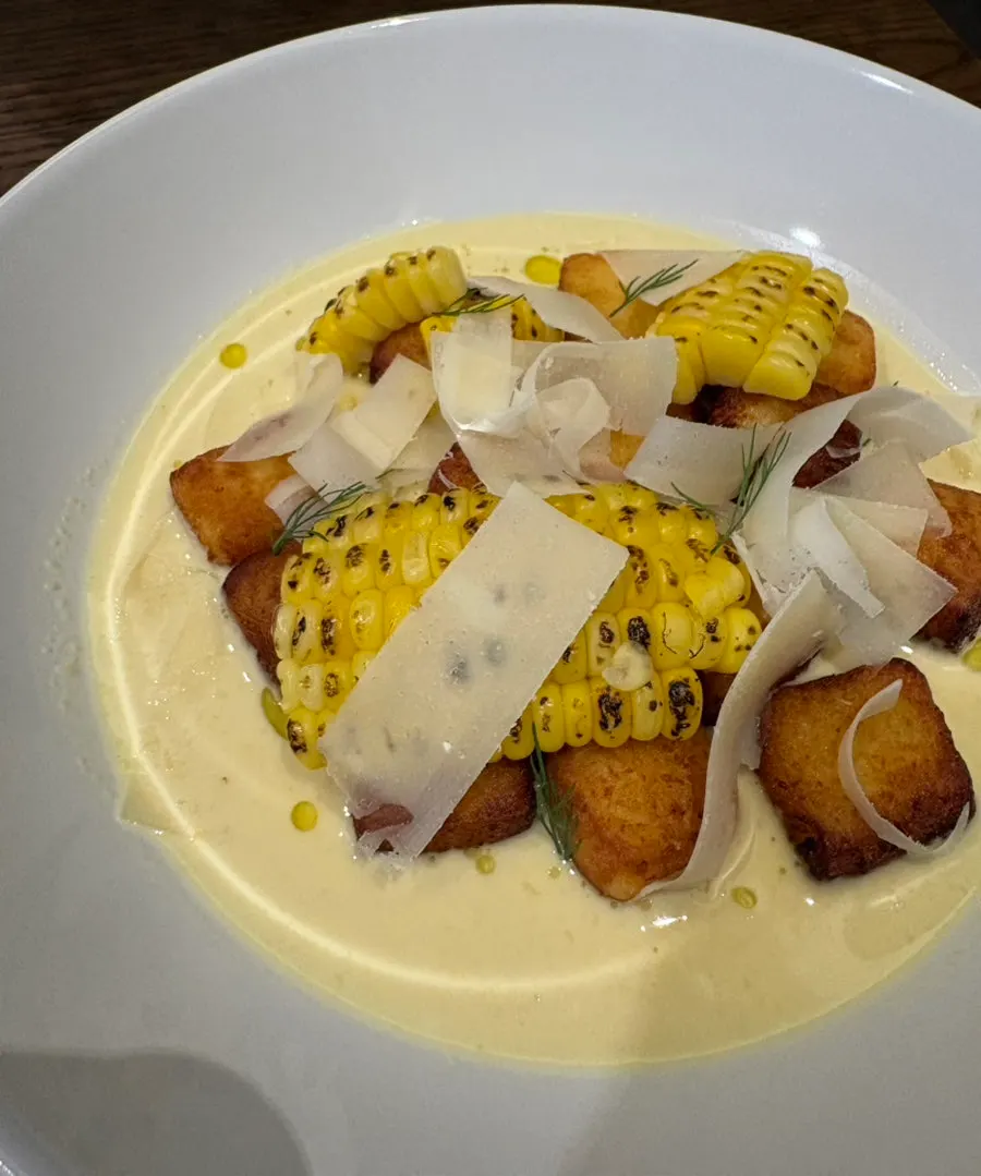 Sweet corn gnocchi covered with thinly sliced cheese