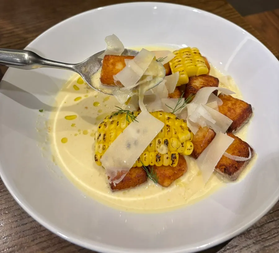 Fried potato gnocchi with sweet corn served in a wide bowl