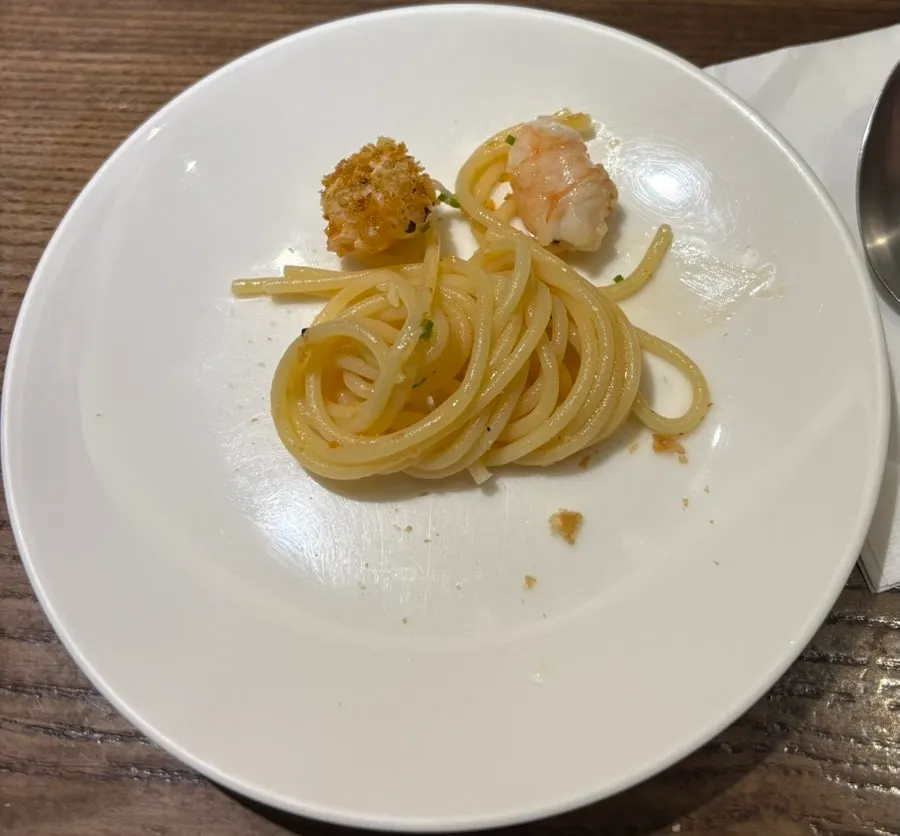 A single piece of fried gnocchi coated in cream sauce
