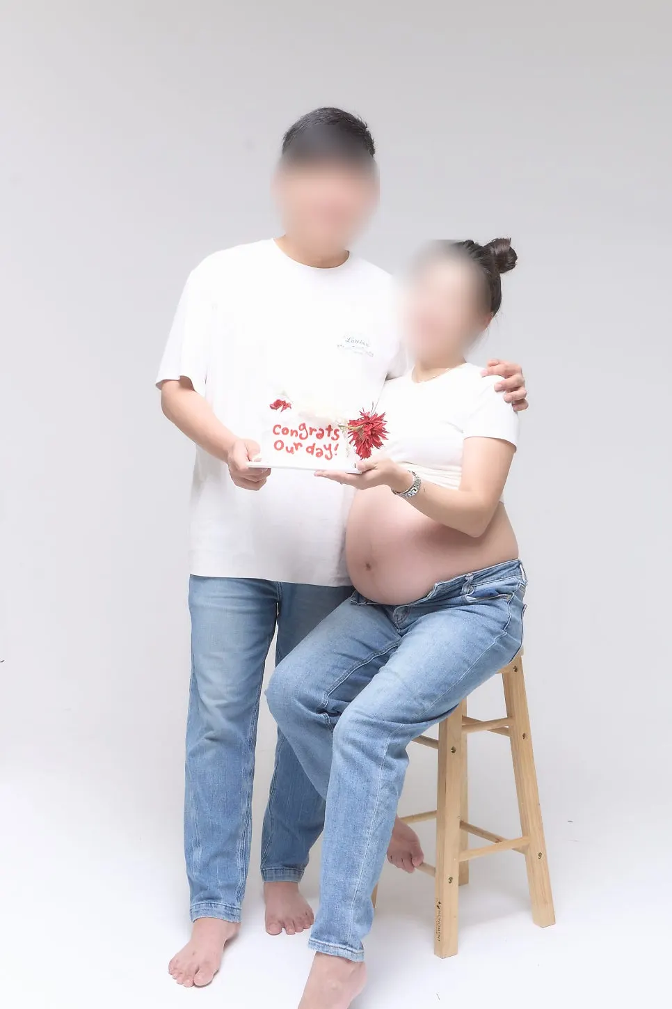 Couple's maternity snap using cheer stick prop