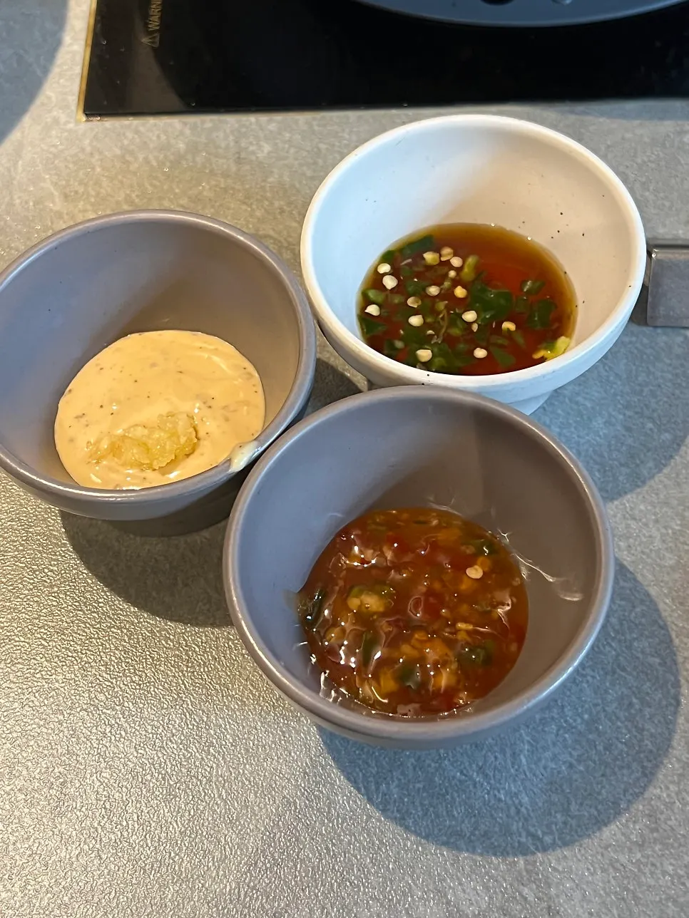 Three shabu dipping sauces: chili, yuzu soy, and sesame