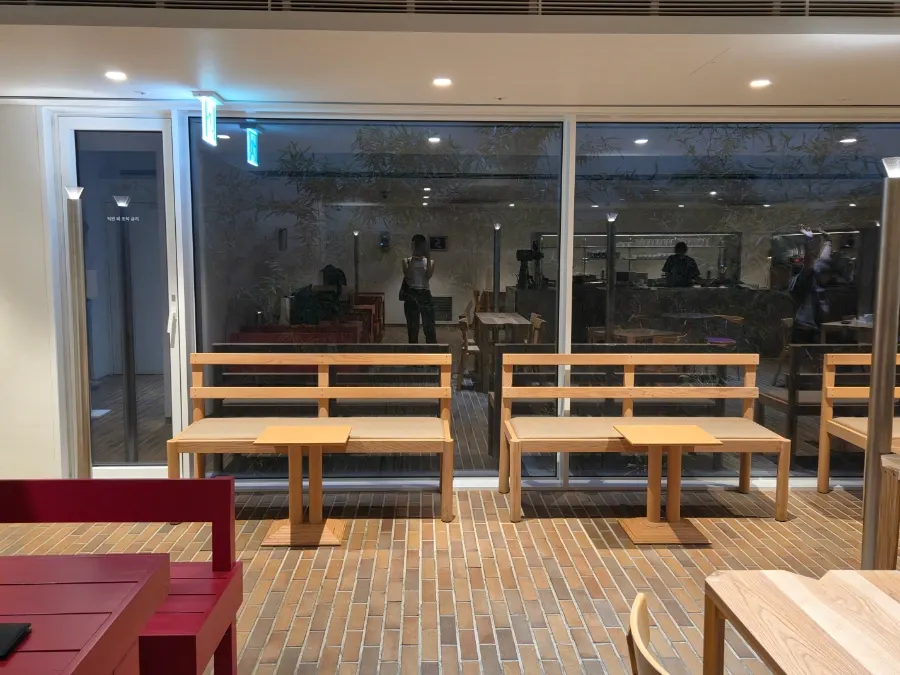 Café space with the window wall visible in the evening
