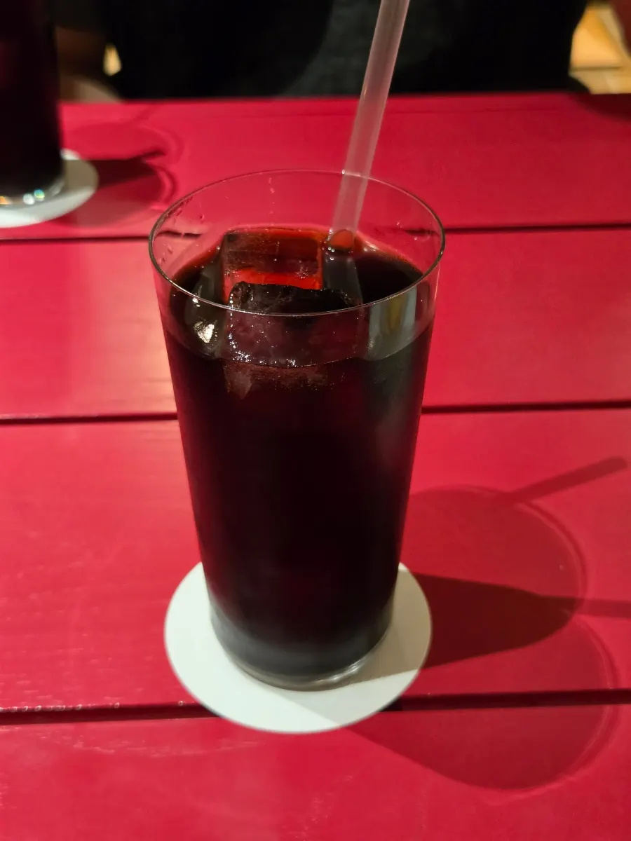 A glass of dark-colored iced cold brew