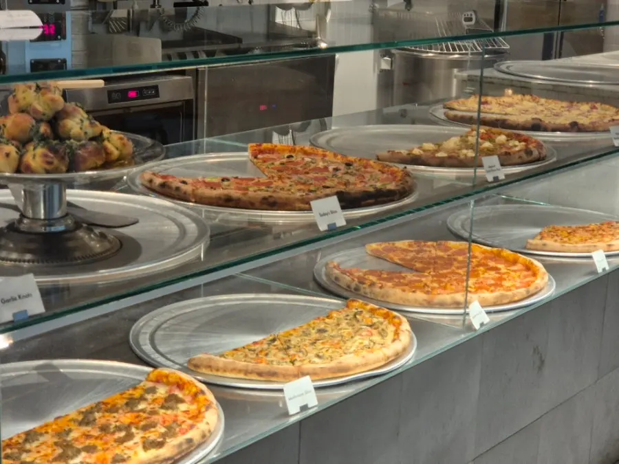 Slice pizza display showcase next to the ordering counter