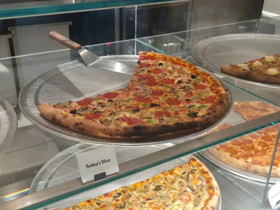 Slice pizzas lined up in the showcase