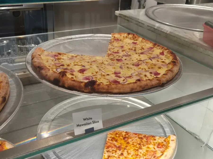 Various slice pizzas including pepperoni on display